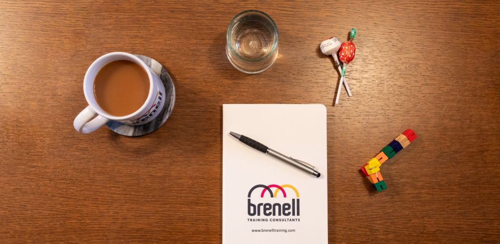 Brenell Training branded stationery on a desk.