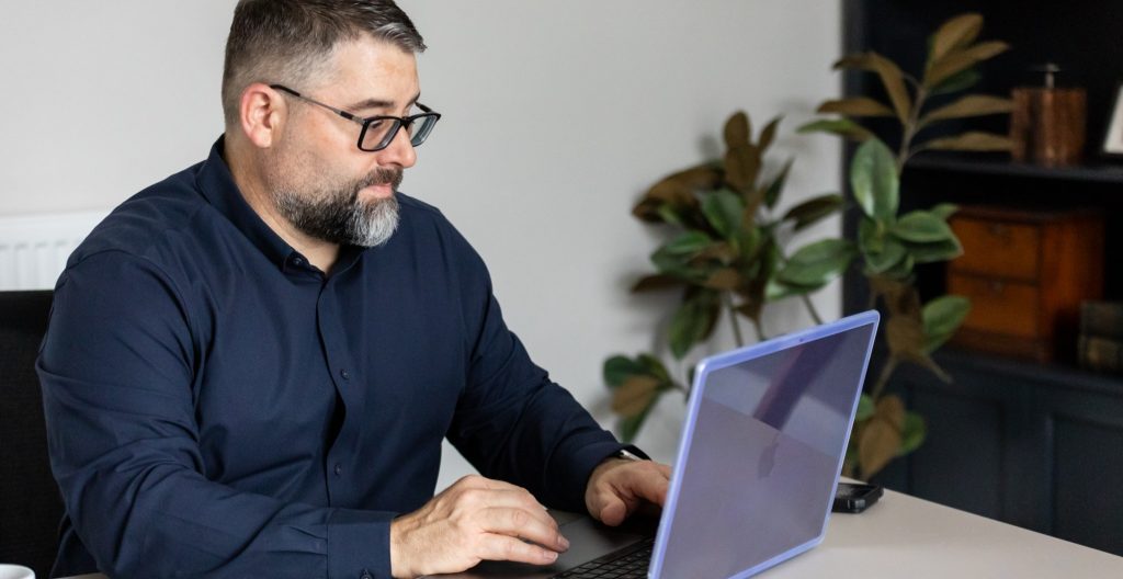 Gareth preparing some training notes on a laptop.